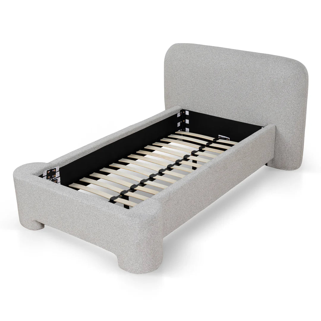 Gray upholstered bed frame with wooden slats on a white background
