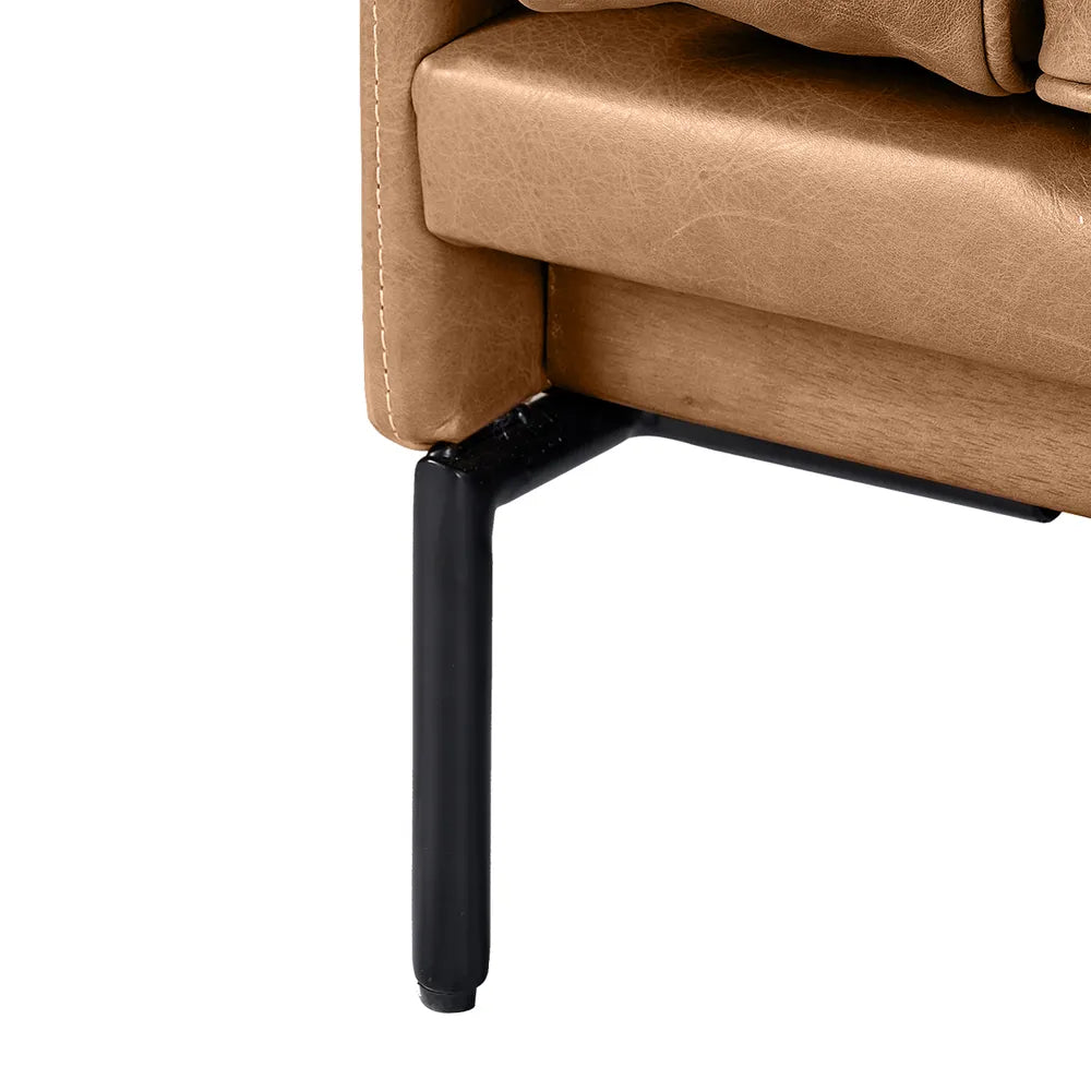 Close-up of a brown leather chair with a black metal leg on a white background