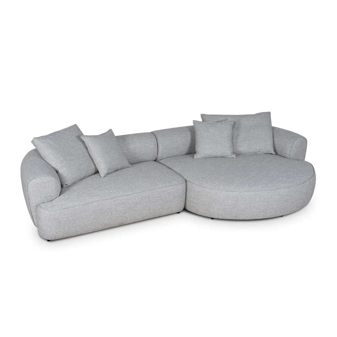 Gray sectional sofa with cushions on a white background