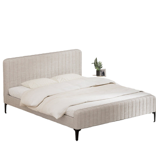 Beige upholstered bed with white bedding in a minimalistic room.