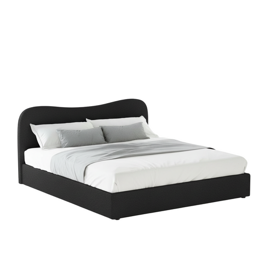 Black bed frame with white bedding in a bright room with plants