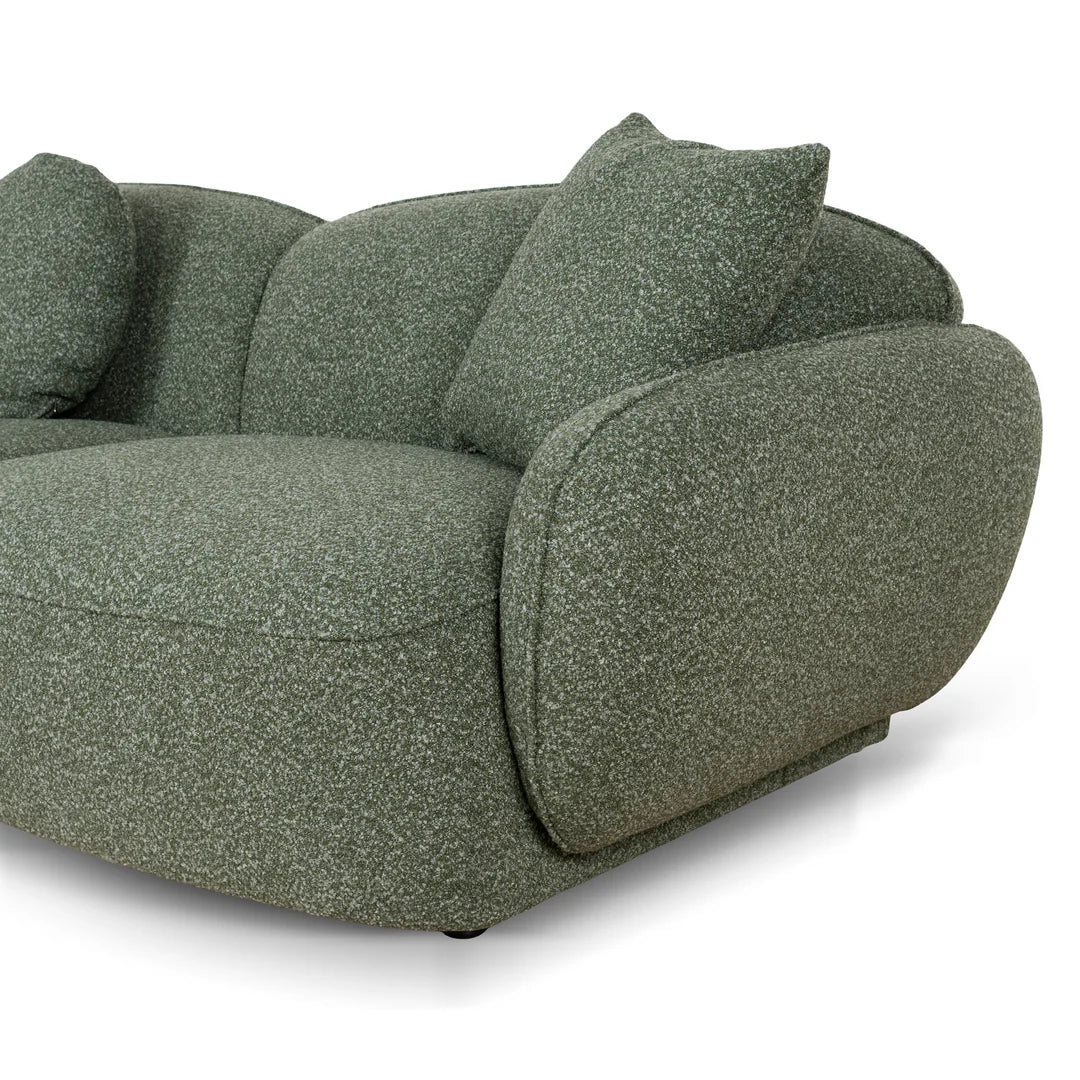 Green textured sofa with cushions on a white background