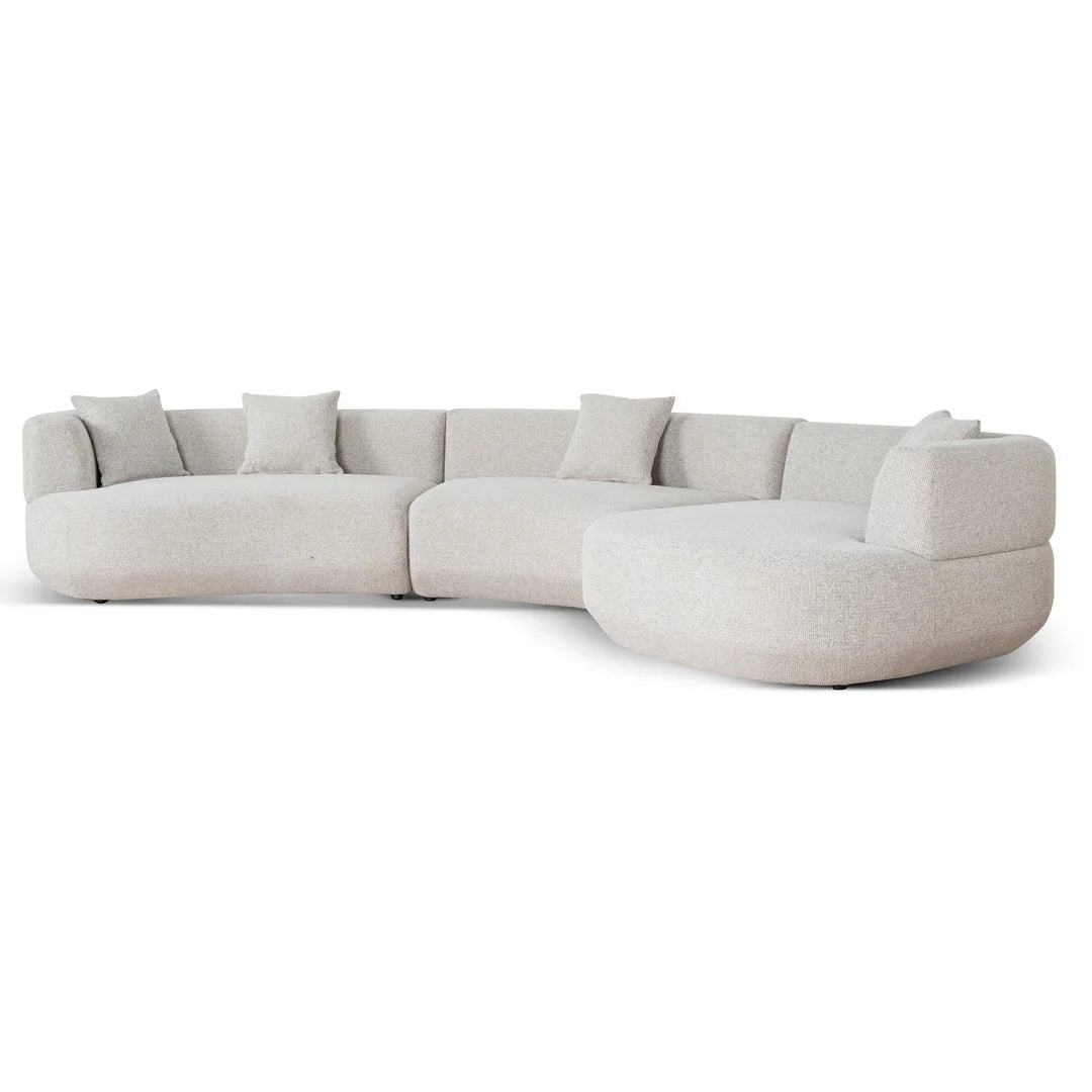 Sectional sofa with round end table on a white background