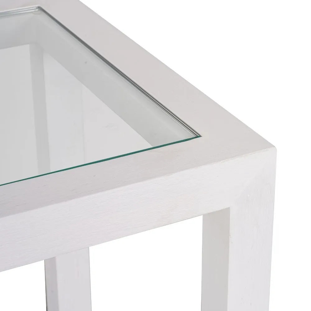 White side table with a clear glass top on a 