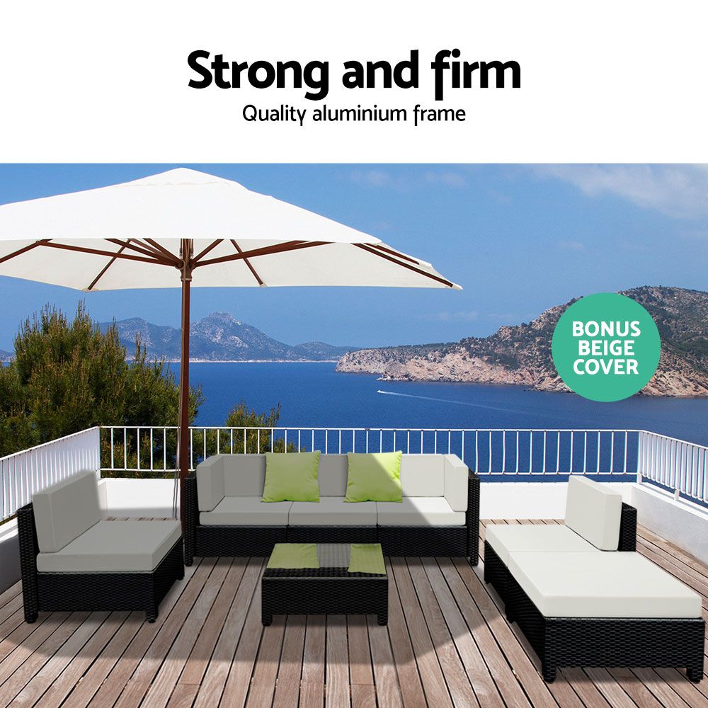Outdoor furniture set with cushions on a deck overlooking a scenic view, featuring a white umbrella and 'Bonus Beige Cover' text.