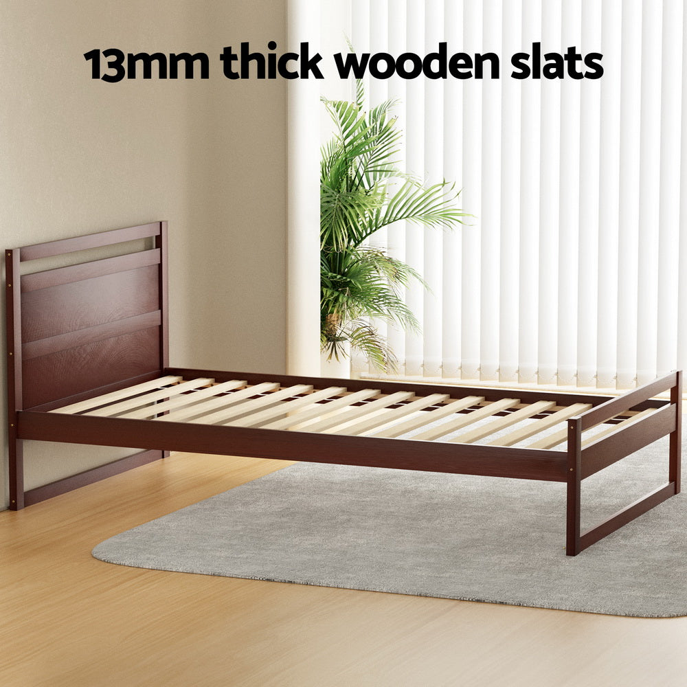 Wooden bed frame with slats in a room with a plant and window blinds.